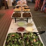A long table with many different types of food.