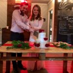 A man and woman cutting their wedding cake.