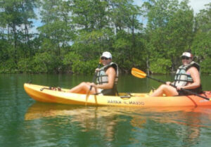 Two people in a yellow kayak on the water.
